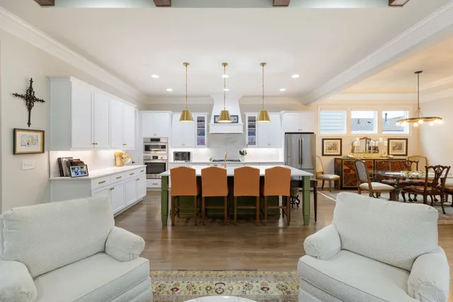 a dining room with furniture a chandelier and wooden floor