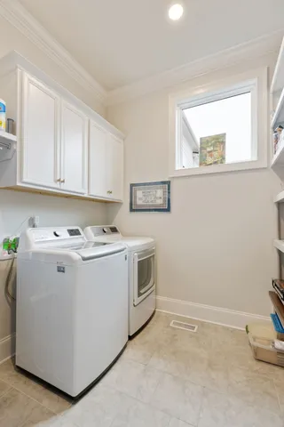 a view of a hallway with furniture and windows