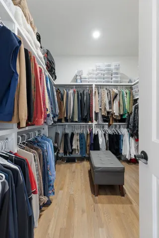 a bathroom with a granite countertop sink a toilet a mirror and bathtub