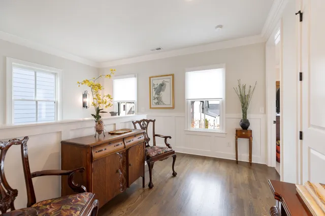 a view of a house with a yard and large tree