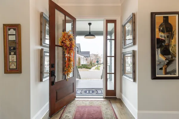 a kitchen with stainless steel appliances kitchen island granite countertop a dining table chairs and white cabinets