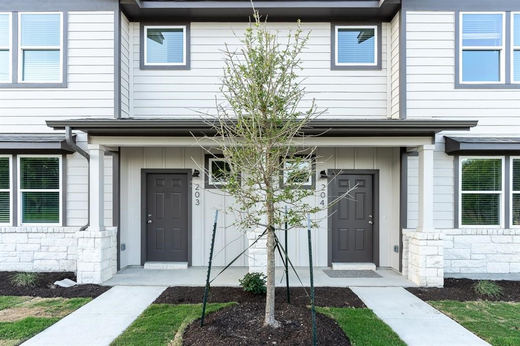 705 Apache Trail, Unit 513 Leander, TX 78641 - Photo 1 of 1 a front view of a house with garden