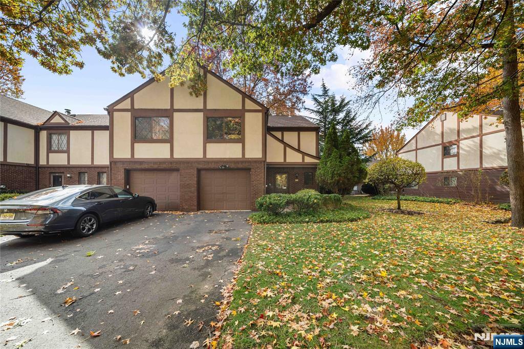 a couple of cars parked in front of a house
