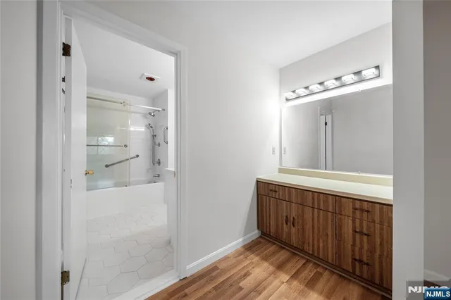 a bathroom with a mirror and a shower