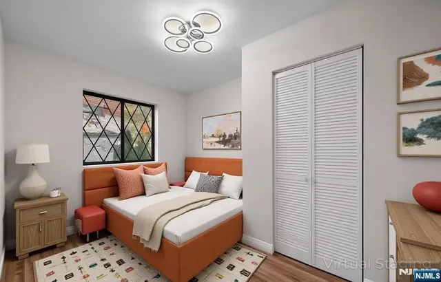 a bedroom with a bed and a painting on the wall