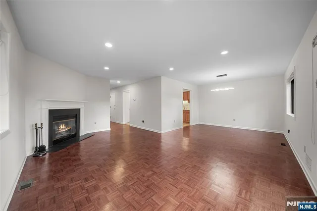 a view of an empty room with a fireplace