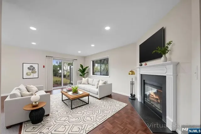 a living room with furniture a flat screen tv and a fireplace
