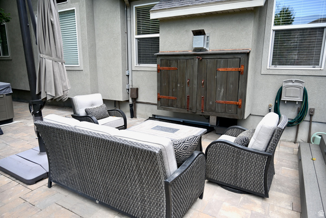 314 Brown Farm Lane Draper, UT 84020 - Photo 40 of 57 Stone paver patio featuring a built-in outdoor cabinet with distressed wood doors