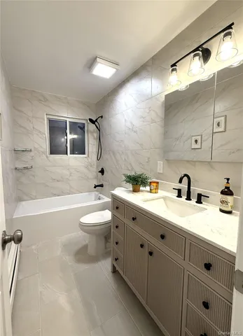 a living room with kitchen island furniture and a kitchen view