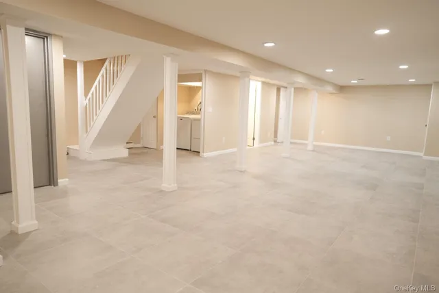 an empty room with windows and pillars in it