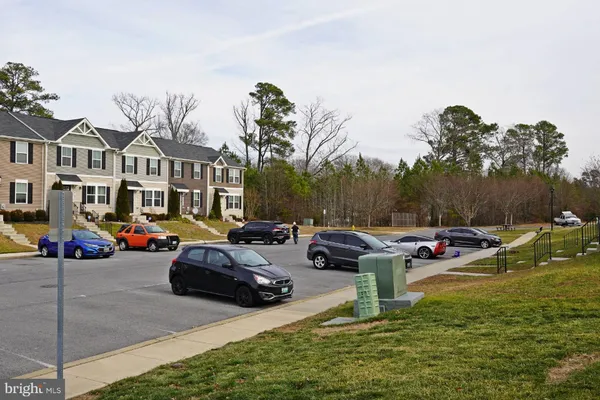 a row of cars parked in front of a house
