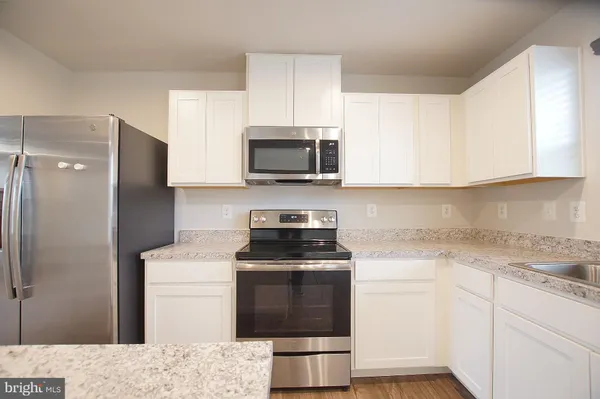 a kitchen with a stove and a microwave