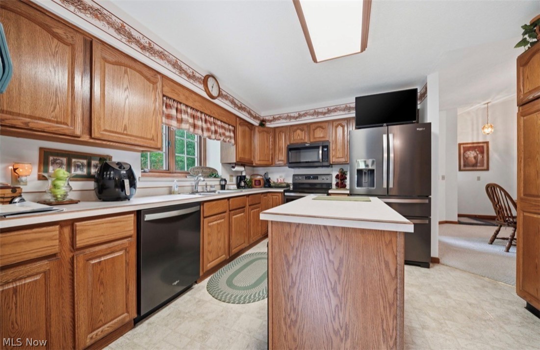 3556 Lake Road Conneaut, OH 44030 - Photo 2 of 39 Kitchen featuring wood-finish cabinetry, white countertops, and contemporary stainless steel appliances including a double-door refrigerator and built-in microwave