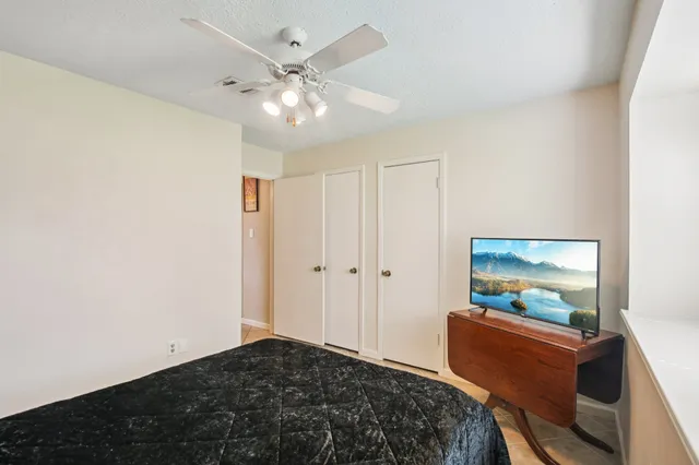 a bedroom with a bed and a flat screen tv