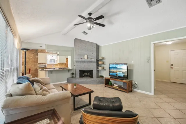 a living room with furniture and a fireplace