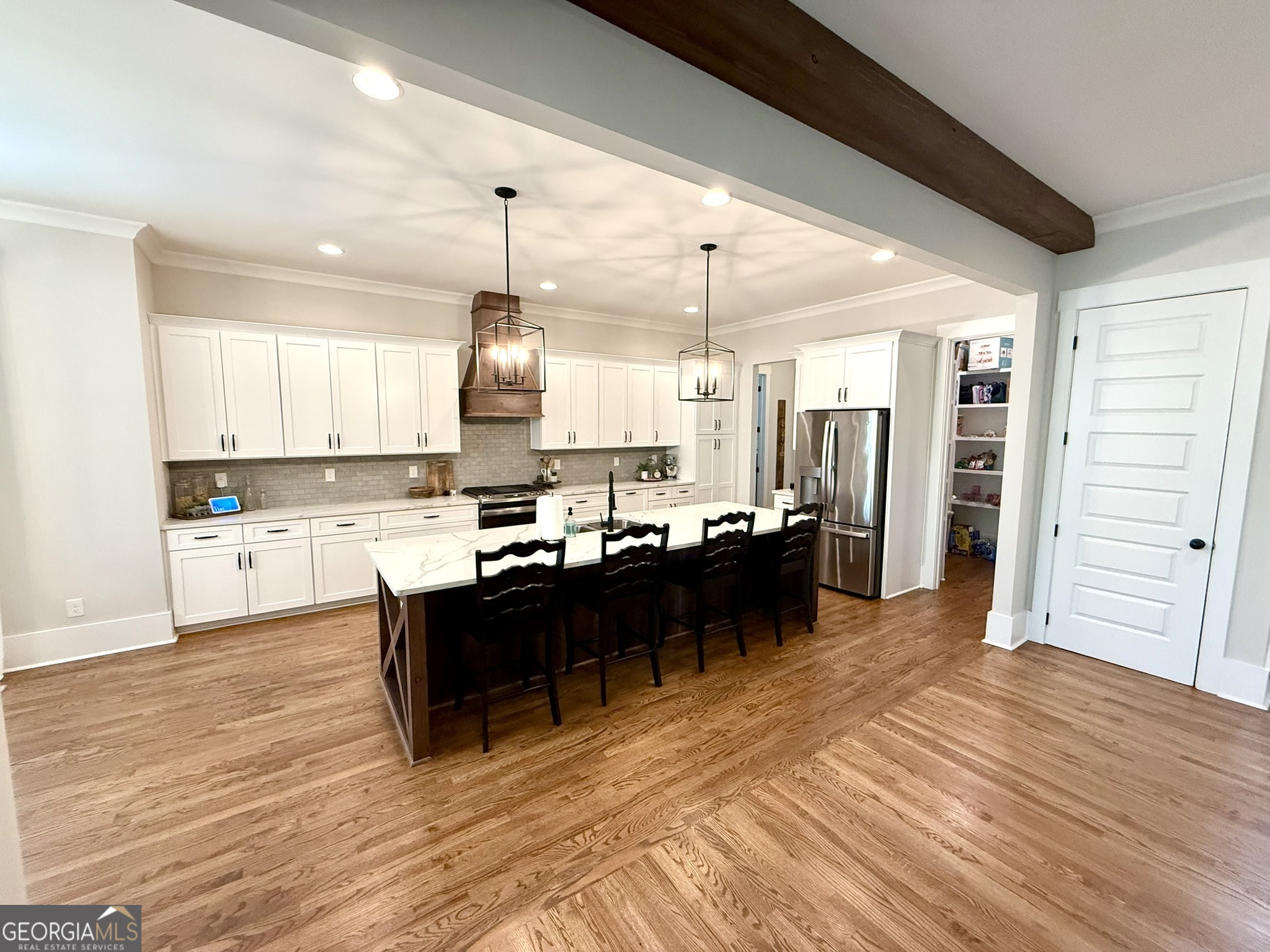 120 Spring Creek Drive Rutledge, GA 30663 - Photo 8 of 38 a large kitchen with a lot of counter space and wooden floor