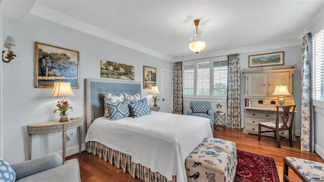 a living room with furniture a rug and white walls