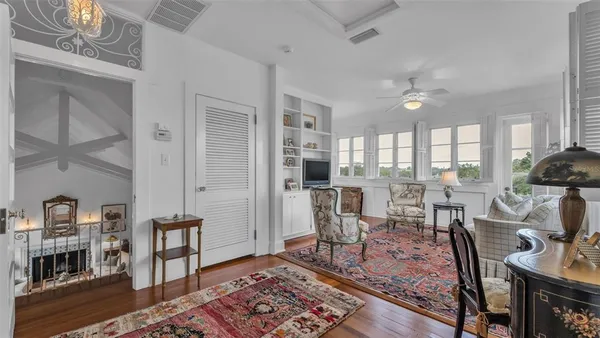 a living room with furniture a rug and white walls