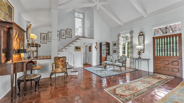 a living room with furniture a rug and a table