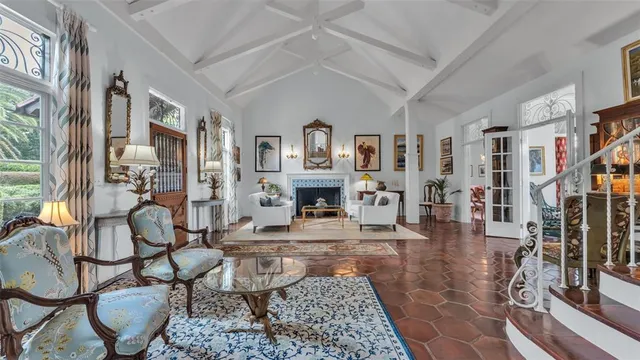 a living room with fireplace furniture and a rug