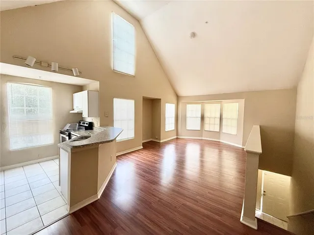 a view of a kitchen with a sink and a large window