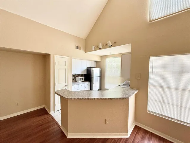 a kitchen with stainless steel appliances granite countertop a sink a stove and a refrigerator