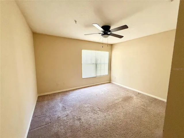 a bathroom with a granite countertop sink a mirror and a bathtub