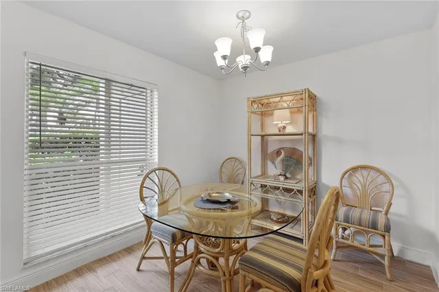 a view of a dining room with furniture and chandelier