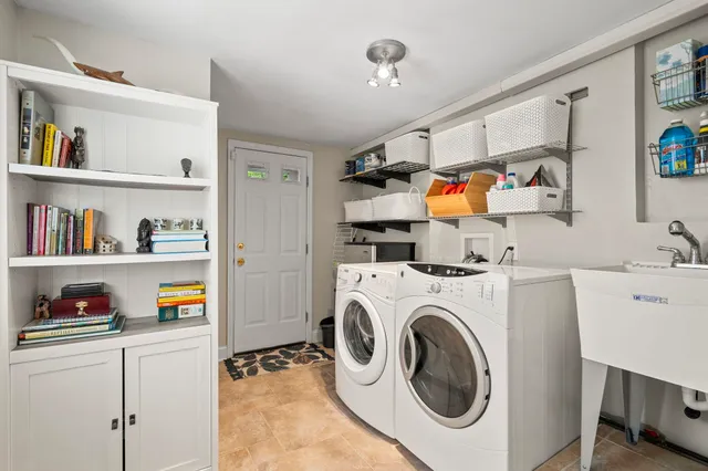 a utility room with dryer washer and a book shelf