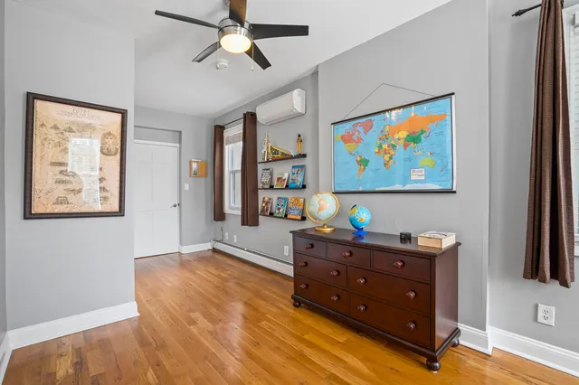 a room with furniture and paintings on the wall