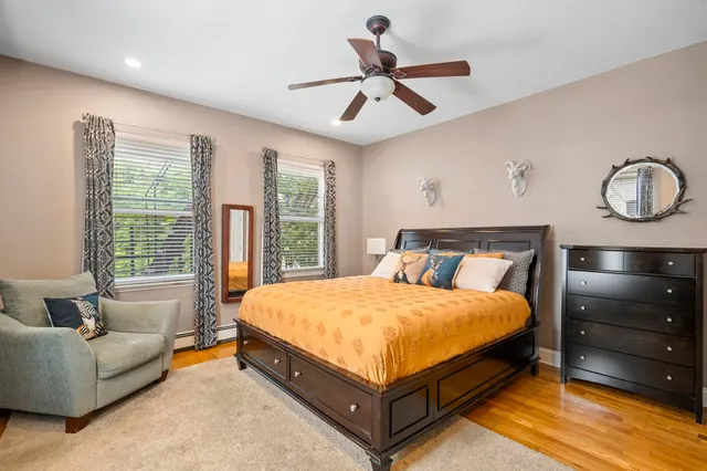 a bed sitting in a bedroom next to a window