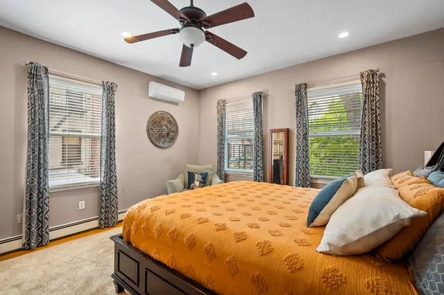 a bed sitting in a bedroom and a chandelier