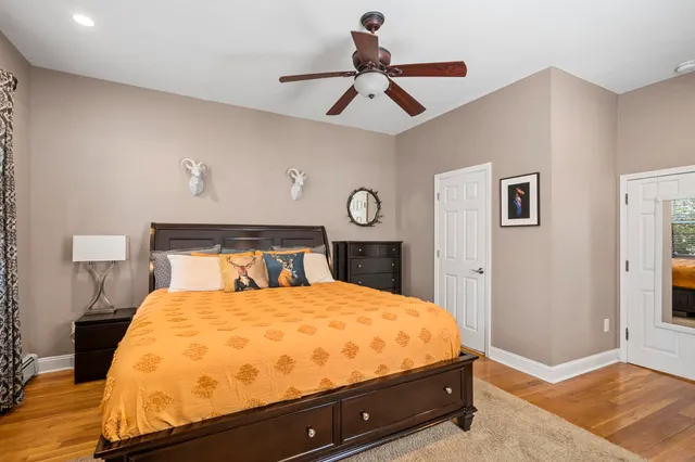 a bathroom with a double vanity sink toilet and mirror