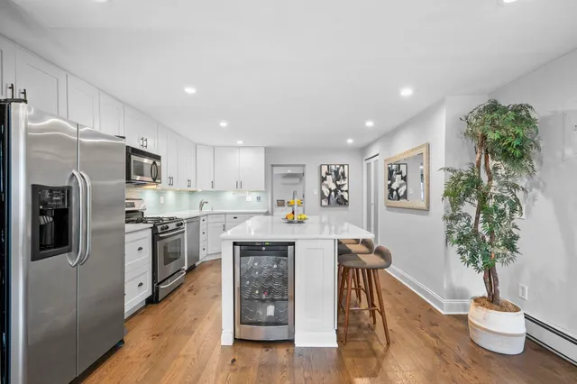 a kitchen with stainless steel appliances a refrigerator and a stove