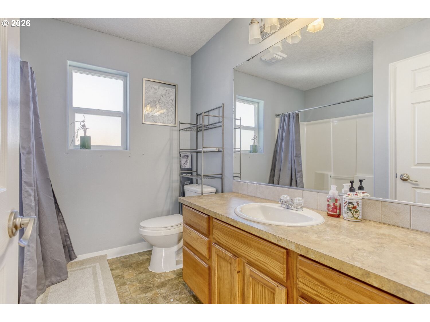 147 Southwest Wright Avenue Troutdale, OR 97060 - Photo 24 of 27 a bathroom with a sink a toilet and a mirror