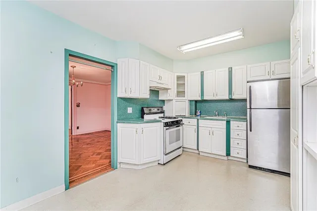 a kitchen with stainless steel appliances a refrigerator sink and cabinets