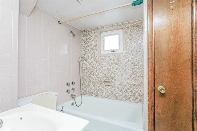 a bathroom with a bathtub and shower