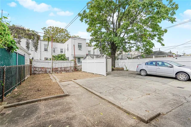 a view of a house with backyard and a garage