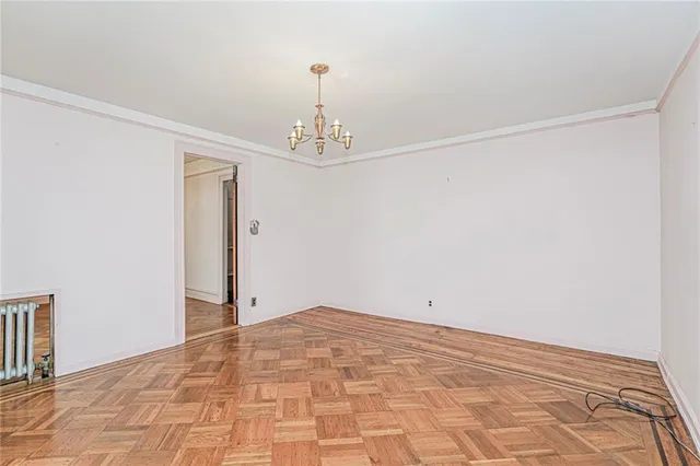 a view of an empty room with a chandelier