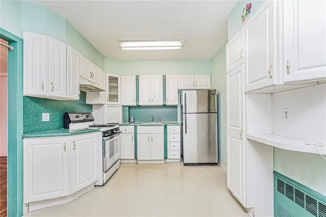 a kitchen with stainless steel appliances granite countertop a refrigerator sink and cabinets