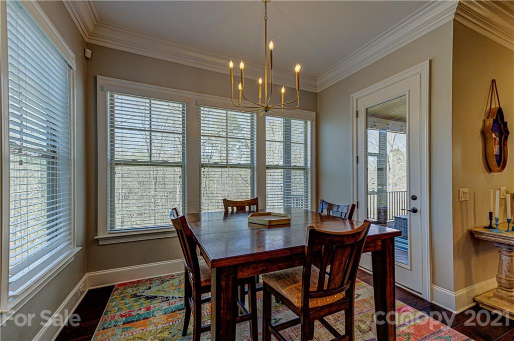 133 Forsythia Lane Tega Cay, SC 29708 - Photo 14 of 48 a view of a dining room with furniture window and wooden floor