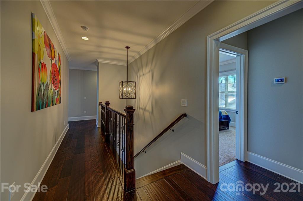 133 Forsythia Lane Tega Cay, SC 29708 - Photo 22 of 48 a view of a hallway with wooden floor and stairs