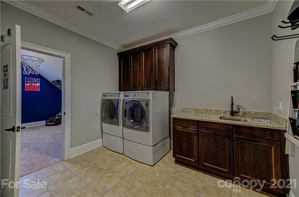 133 Forsythia Lane Tega Cay, SC 29708 - Photo 33 of 48 a utility room with dryer and washer