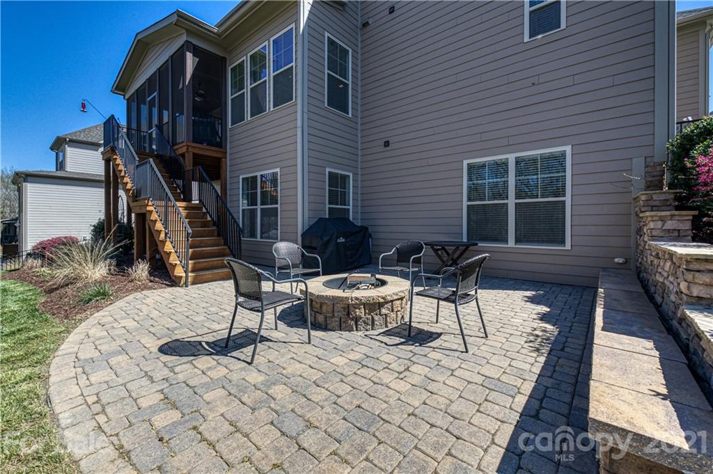 133 Forsythia Lane Tega Cay, SC 29708 - Photo 42 of 48 a view of a patio with table and chairs potted plants with wooden walls