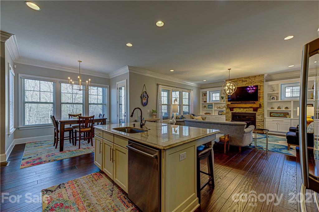 133 Forsythia Lane Tega Cay, SC 29708 - Photo 8 of 48 a kitchen with stainless steel appliances granite countertop a stove and a wooden floors