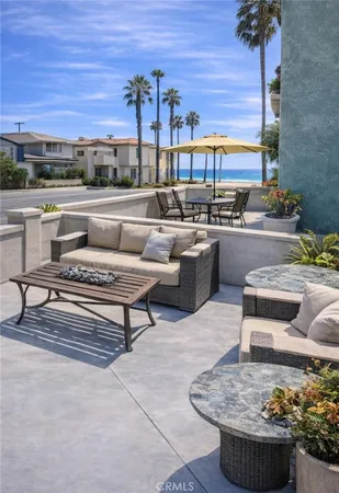 a living room with couches and a potted plant