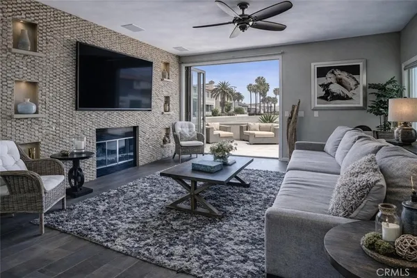 a living room with furniture a flat screen tv and a fireplace