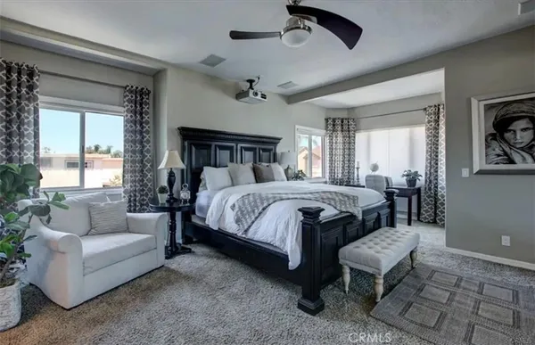 a bedroom with a bed a couch and a window