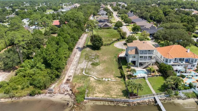 an aerial view of residential houses with outdoor space and street view