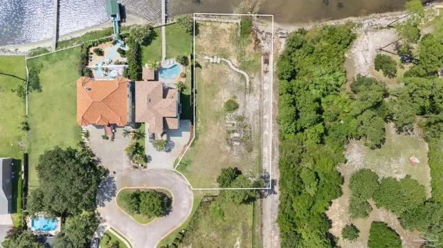 an aerial view of residential house with outdoor space and swimming pool